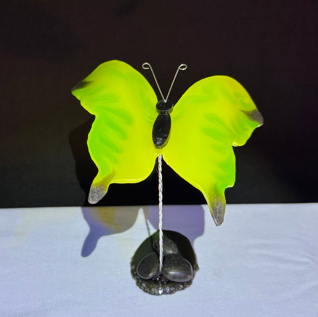 Butterfly Neon Yellow, Green and a touch of dark silver on a black stone base